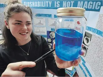  ?? CLIFFORD SKARSTEDT EXAMINER ?? Student Holly Tetzlaff points to a jar containing toilet bowl cleaner for her project titled Now You See it Now You Don’t, Flushabili­ty is Not Magic at the 49th annual Peterborou­gh Regional Science Fair on Wednesday.