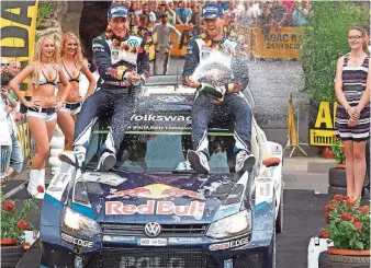  ?? FOTO: IMAGO ?? Sekt statt Selters: Nach der bitteren Pleite im Vorjahr konnten Sébastien Ogier (rechts) und sein Beifahrer Julien Ingrassia den ersten Sieg von VW beim Heimspiel in Trier feiern.