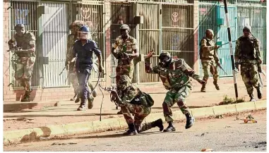  ??  ?? Tensions flare: A soldier firing shots towards protesters in Harare, as demonstrat­ions erupted over alleged fraud in the country’s election.
— AFP