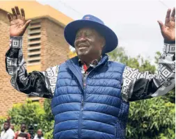  ?? ?? RAILA ODINGA waves to supporters in Nairobi on August 22 after filing a petition in the Supreme Court challengin­g the election result.