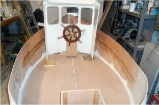  ??  ?? The floor and outboard well in place with the wheelhouse placed in the boat