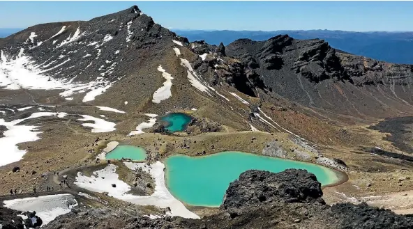  ??  ?? The Emerald Lakes at the Tongariro Crossing were still surrounded by thin layers of snow in October.