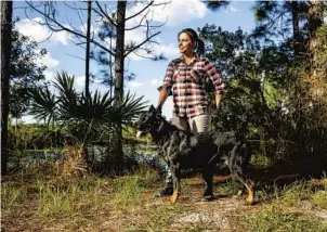  ??  ?? Paige Johnson stands with her Beauceron, Harbin, at Econ River Wilderness Area.