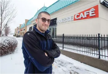  ?? RYAN REMIORZ/THE CANADIAN PRESS ?? Sami Bizri, co-owner of a Presse Cafe franchise at the Faubourg Boisbriand shopping centre, says the Boisbriand community seems to have weathered the storm when a GM plant closed in the Quebec town in 2002. He works at the site of the former GM factory.