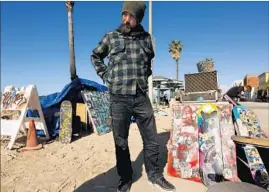  ?? Genaro Molina Los Angeles Times ?? REED SEGOVIA, a homeless artist, at his stand along the Venice boardwalk. A new homeless housing proposal would also allocate units for low-income artists.