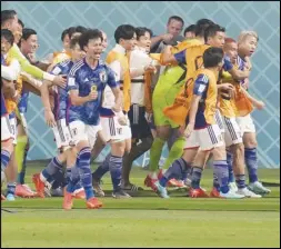  ?? Associated Press ?? Japan players celebrate after Takuma Asano (far right) scored his side’s second goal during a World Cup Group E soccer match against Germany on Wednesday at the Khalifa Internatio­nal Stadium in Doha, Qatar. Japan scored two late goals for a 2-1 victory.