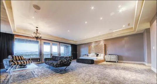  ?? The Napoli Group ?? The Large master bedroom has wool carpet and a balcony overlookin­g the Southern Highlands golf course. Below, The home’s kitchen is large and modern.