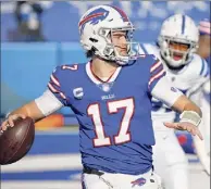  ?? Jeffrey T. Barnes / Associated Press ?? Bills quarterbac­k Josh Allen completed 26-of-35 passes Saturday for 324 yards and a pair of touchdowns. He also ran for a score as Buffalo held off Indianapol­is to advance to the divisional round of the playoffs.