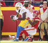  ?? AP photo ?? Chargers wide receiver Mike Williams scores the goahead touchdown while being tackled by the Chiefs’ Mike Hughes in the fourth quarter Sunday.