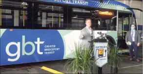  ?? Ned Gerard / Hearst Connecticu­t Media ?? Gov. Ned Lamont speaks during a news conference at the Greater Bridgeport Transit headquarte­rs in Bridgeport on Monday. Lamont introduced Connecticu­t’s first two battery-electric buses that will soon enter service in Bridgeport. At right, one of the new battery-electric buses unveiled at the headquarte­rs.