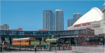  ?? STEPHEN MIDDLETON ?? GER No. 63 had the honour of representi­ng Stately Trains in Canada as part of The Railway Children theatre production, which had been shipped across Atlantic. A purpose-built theatre with 1000 seats was constructe­d in Toronto's Roundhouse Park beneath the CN Tower and next to the Rogers Centre which stands on the former railway lands. The ‘Roundhouse' is a preserved locomotive roundhouse which is home to the Toronto Railway Museum. Between performanc­es LSWR T3 4-4-0 locomotive No. 563 (now under overhaul at the Flour Mill for the Swanage Railway) and the GER carriage were posed on the large turntable.