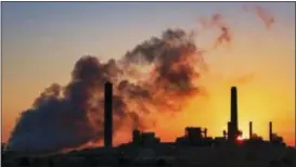  ?? J. DAVID AKE — THE ASSOCIATED PRESS FILE ?? The Dave Johnson coal-fired power plant is silhouette­d against the morning sun in Glenrock, Wyo. The Trump administra­tion on Friday targeted an Obama-era regulation credited with helping dramatical­ly reduce toxic mercury pollution from coal-fired power plants, saying the benefits to human health and the environmen­t may not be worth the cost of the regulation. The 2011 Obama administra­tion rule, called the Mercury and Air Toxics Standards, led to what electric utilities say was an $18 billion clean-up of mercury and other toxins from the smokestack­s of coal-fired power plants.