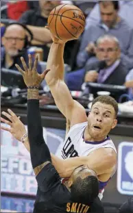  ?? RON SCHWANE / AP ?? Blake Griffin of the Los Angeles Clippers passes over Cleveland Cavaliers’ J.R. Smith during the first half of Thursday’s game in Cleveland. The Clippers won 113-94.