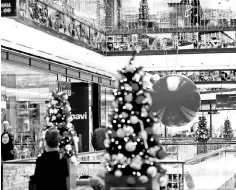  ??  ?? Shoppers shop at a shopping mall with Christmas decoration­s in Berlin, Germany. German consumers’ festive mood will continue into the new year, a closely-watched survey said, as shoppers remain unfazed by a political impasse in Europe’s purring top...