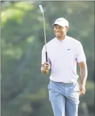  ?? Andrew Redington / Getty Images ?? Tiger Woods smiles as he walks on the 18th green during the third round of the Masters at Augusta National Golf Club on Saturday in Augusta, Ga. Woods is tied for second place heading into the final round.