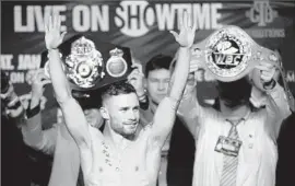  ?? John Gurzinski Agence France-Presse/Getty Images ?? CARL FRAMPTON won a wildly entertaini­ng featherwei­ght title bout against Leo Santa Cruz in July and showed off the belts at weigh-in for tonight’s rematch.