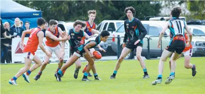  ??  ?? Above: Cora Lynn’s Tristan FranadezPh­illips gathers possession during the under 18 second semi final against Buln Buln