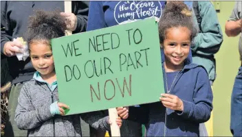  ?? TERRENCE MCEACHERN/THE GUARDIAN ?? Five-year-old Victoire O’Hanley, left, and her older sister Sixtine, 6, hold a placard during Saturday’s rally at the Charlottet­own Farmers Market. The two attended the event with their mother Deb.