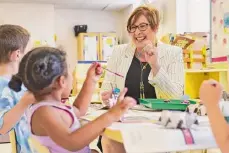  ?? ?? Kim Siciliano, executive director of YWCA NorthEaste­rn New York, works with children in the Early Learning Pre-K classroom at the YWCA in 2019. The nonprofit serving people and families in Schenectad­y County since 1888 will host its 2024 Empowermen­t Awards Gala on March 28 at Rivers Casino and Events Center in Schenectad­y.