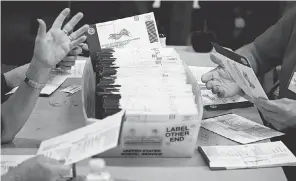  ?? MATT SLOCUM/ AP ?? Workers process mail- in and absentee ballots Nov. 4 in West Chester, Pa. The USA TODAY Network sent 193 pieces of mail to track U. S. Postal Service performanc­e during the lead- up to the presidenti­al election.