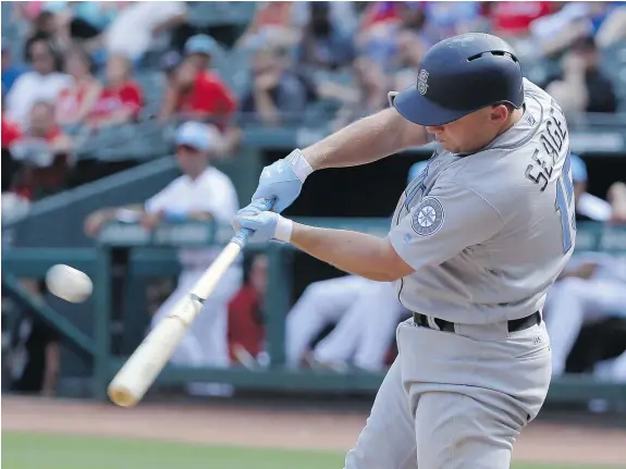  ?? — THE ASSOCIATED PRESS ?? Seattle’s Kyle Seager bangs out one of his three doubles in Sunday’s 7-3 victory over the Texas Rangers in Arlington.