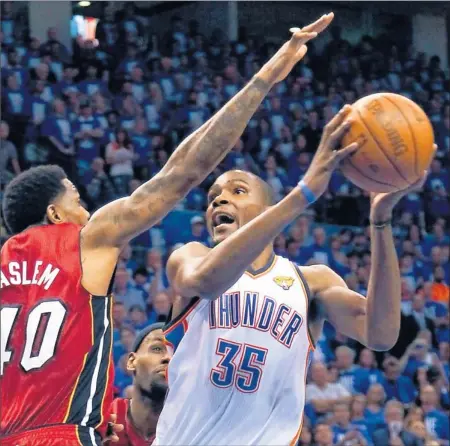  ?? By Derick E. Hingle, US Presswire ?? Clutch: The Thunder’s Kevin Durant, right, driving to the basket against the Heat’s Udonis Haslem, scored 36 points, including 17 in the fourth quarter.