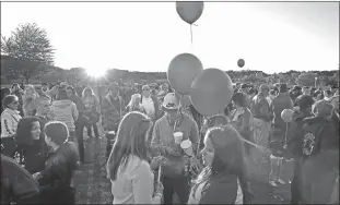  ?? MEL EVANS/AP ?? Hundreds of people gather by the fading light of sunset for an anti-bullying rally in Sayreville, N.J.