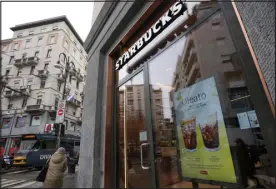  ?? ANTONIO CALANNI — THE ASSOCIATED PRESS ?? A Starbucks sign advertises the company’s Oleato coffee in one of its coffee shops in Milan, Italy, on Monday.