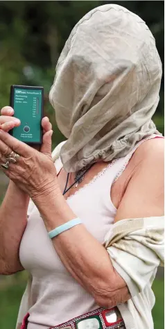  ??  ?? Fighting back: Rosi Gladwell with her protective hood and signal meter. Right, Julie Harrison