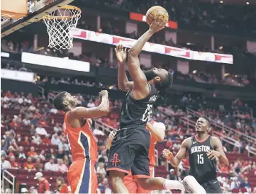  ?? — USA TODAY Sports photo ?? Houston Rockets guard James Harden (right) shoots the ball as New Orleans Pelicans guard DeAndre Liggins defends during the first quarter at Toyota Centre.