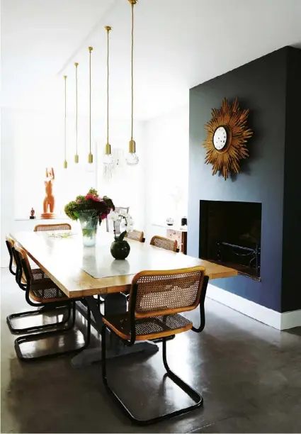  ??  ?? The dining area ‘I hated these 1970s chairs from my childhood, so I sprayed the chrome black,’ says Stiegler. ‘Then Max [her son] told me they are Arrben originals, so I should learn to love them.’
Above right Stiegler’s parents, Catherine Sinclair...