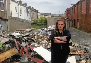  ??  ?? Nova Desoer with the pile of rubbish in an alleyway at the back of her home