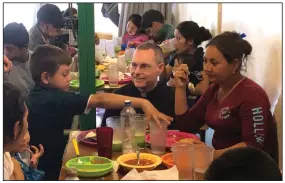  ?? (AP/David Crary) ?? Jesuit priest Sean Carroll meets in February with a group of asylum-seekers in the cafeteria of a migrant-outreach center that his organizati­on, the Kino Border Initiative, operates in Nogales, Mexico, near the U.S. border.