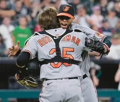  ?? HUH/AP ?? Orioles relief pitcher Jorge Lopez, rear, celebrates with catcher Adley Rutschman after a 4-1 win over the White Sox on Friday in Chicago. Two days before promoting Rutschman, the Orioles were 14-24. They are 20-15 since, their best 35-game stretch in five years. NAM Y.