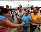  ?? Photo: AFP ?? Relatives of the prisoners at the Zone 8 Deprivatio­n of Liberty Center are seen as they wait for news in Guayaquil, Ecuador on Tuesday.