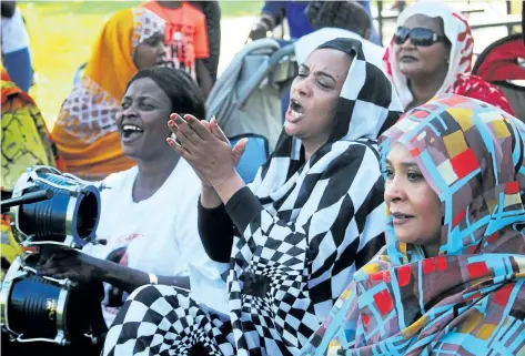  ?? BERND FRANKE/POSTMEDIA NEWS ?? Members of the Sudanese-Canadian community in Niagara cheer on the host team at a men’s soccer tournament Saturday at Pearson Park in St. Catharines.