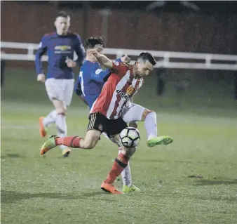  ??  ?? George Honeyman battles against Manchester United last night