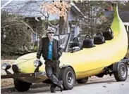  ?? TAKAAKI IWABU/MCT ?? Steve Braithwait­e poses by the 23-foot banana-shaped car he’s driving across the U.S., offering trips as he goes.