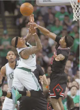  ?? STAFF PHOTO BY JOHN WILCOX ?? NO WAY: Rajon Rondo swats a shot by Isaiah Thomas during the Bulls’ Game 2 win over the Celts last night at the Garden.