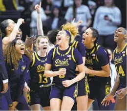  ?? CLOE POISSON AP ?? Notre Dame guard Hannah Hidalgo (3), who had a season-high 34 points, and teammates celebrate a win over No. 8 Uconn on Saturday in Storrs, Conn.