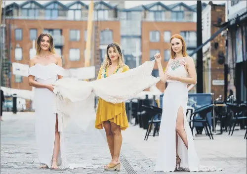  ?? PICTURE: NEIL HOLMES. ?? NEW UNION: Ghost Orchid Bride owner Katey Headley, centre, with past customers Joanne Hill, left, and Hayley Sykes, in Hull’s Fruit Market waterfront quarter.