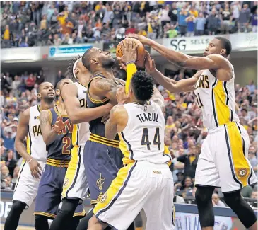  ?? USA TODAY SPORTS ?? The Cavaliers’ LeBron James, centre, battles for a rebound against the Pacers’ Thaddeus Young, right, and Jeff Teague.