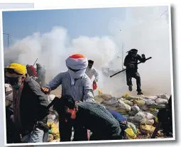  ?? Picture: REUTERS ?? Farmers run for cover as police fires tear gas during a protest, as farmers march towards New Delhi to press for better crop prices promised to them in 2021, at Shambhu barrier, a border crossing between Punjab and Haryana states, India, February 21, 2024.