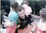  ?? — Reuters ?? A crew member hugs a migrant child aboard the Aquarius rescue ship before disembarki­ng in the port of Valencia, Spain, on Sunday.