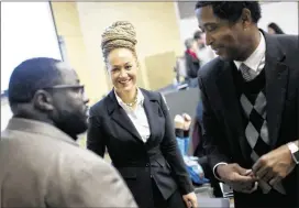  ?? TYLER TJOMSLAND / ASSOCIATED PRESS ?? Rachel Dolezal (center), the NAACP president in Spokane, Washington, smiles as she meets with leaders earlier this year before the start of a Black Lives Matter Teach-In. Dolezal’s parents said this week she is actually white.