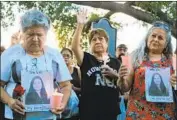  ?? Susan Montoya Bryan Associated Press ?? FAMILY and friends of four slain women take part in a candleligh­t vigil in Laredo, Texas, in September.