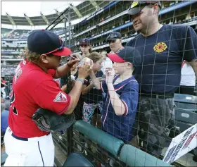  ?? TIM PHILLIS — FOR THE NEWS-HERALD ?? Josh Naylor signs an autograph before the Guardians-Twins game June 27at Progressiv­e Field.