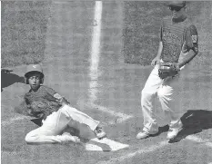  ?? GENE J. PUSKAR/THE ASSOCIATED PRESS ?? Venezuela’s Jhann Bozo scores from third on a wild pitch by Mexico pitcher Jorge Garcia, right, in their game last Thursday in Williamspo­rt, Pa. Venezuela played an eliminatio­n game against a team from the Dominican Republic on Monday.