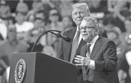  ?? CAROLYN KASTER/AP ?? President Donald Trump stands with gubernator­ial candidate Mike Dewine in Cleveland on Nov. 5, 2018. As Trump moves out of the White House, Ohio Republican­s are left to decide whether their embrace of Trump will persist.