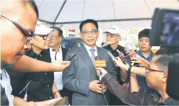  ?? — Photo by Muhammad Rais Sanusi ?? Abdul Karim speaks to reporters after officiatin­g at the VSC Car Sticker Launch.